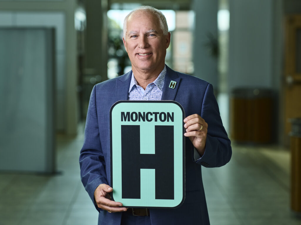 Wayne  Holding H Sign and Smiling at camera