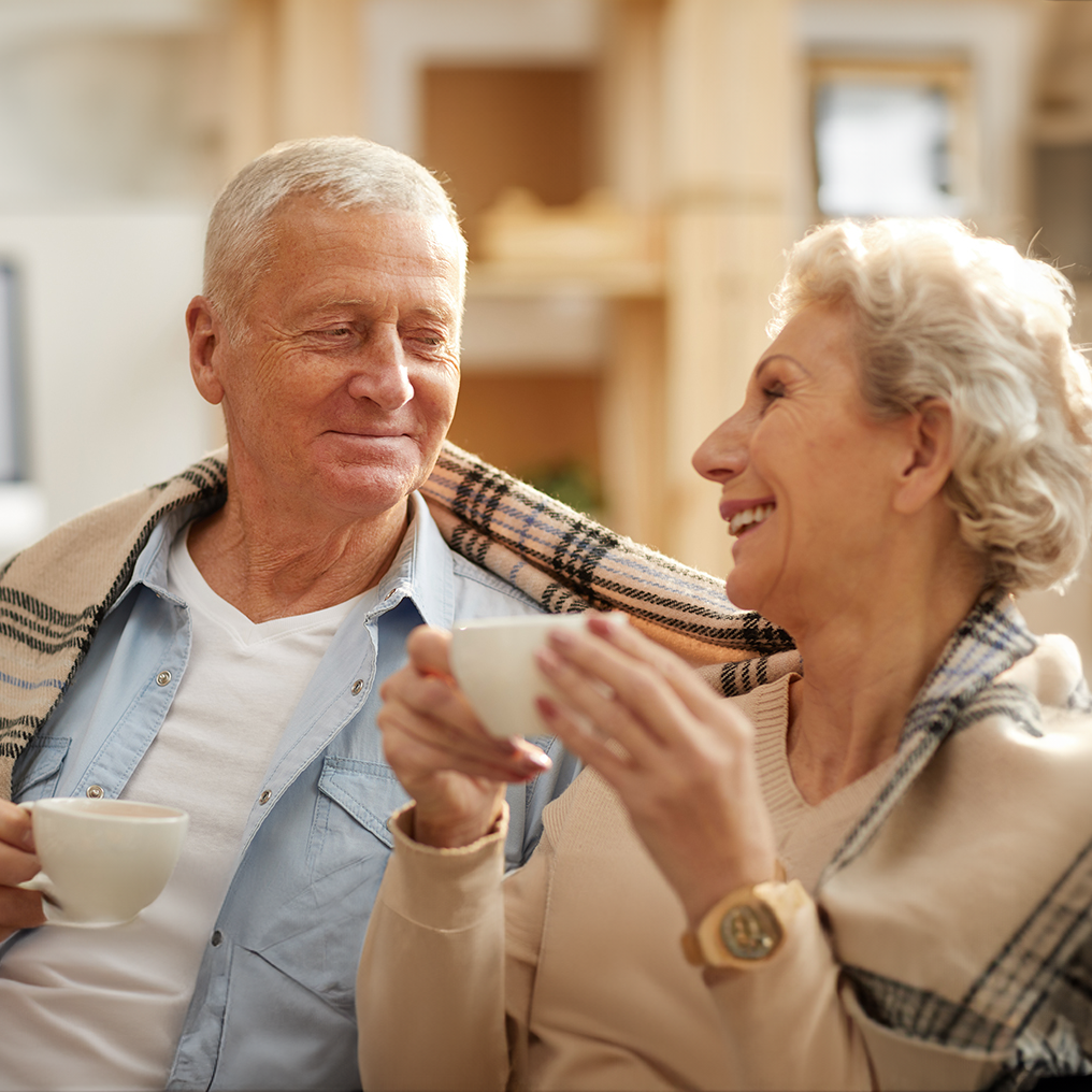 Senior Couple smiling having tea
