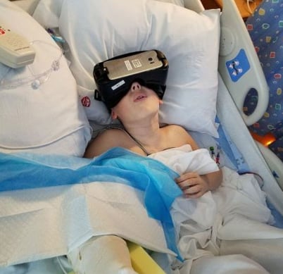 Child in hospital using VR goggles