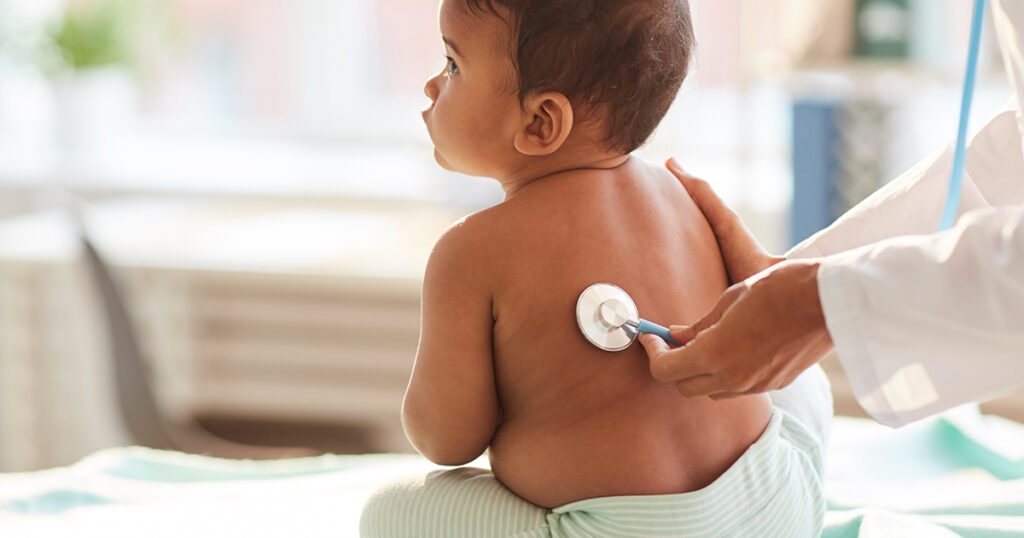 Health professional with stethoscope and baby